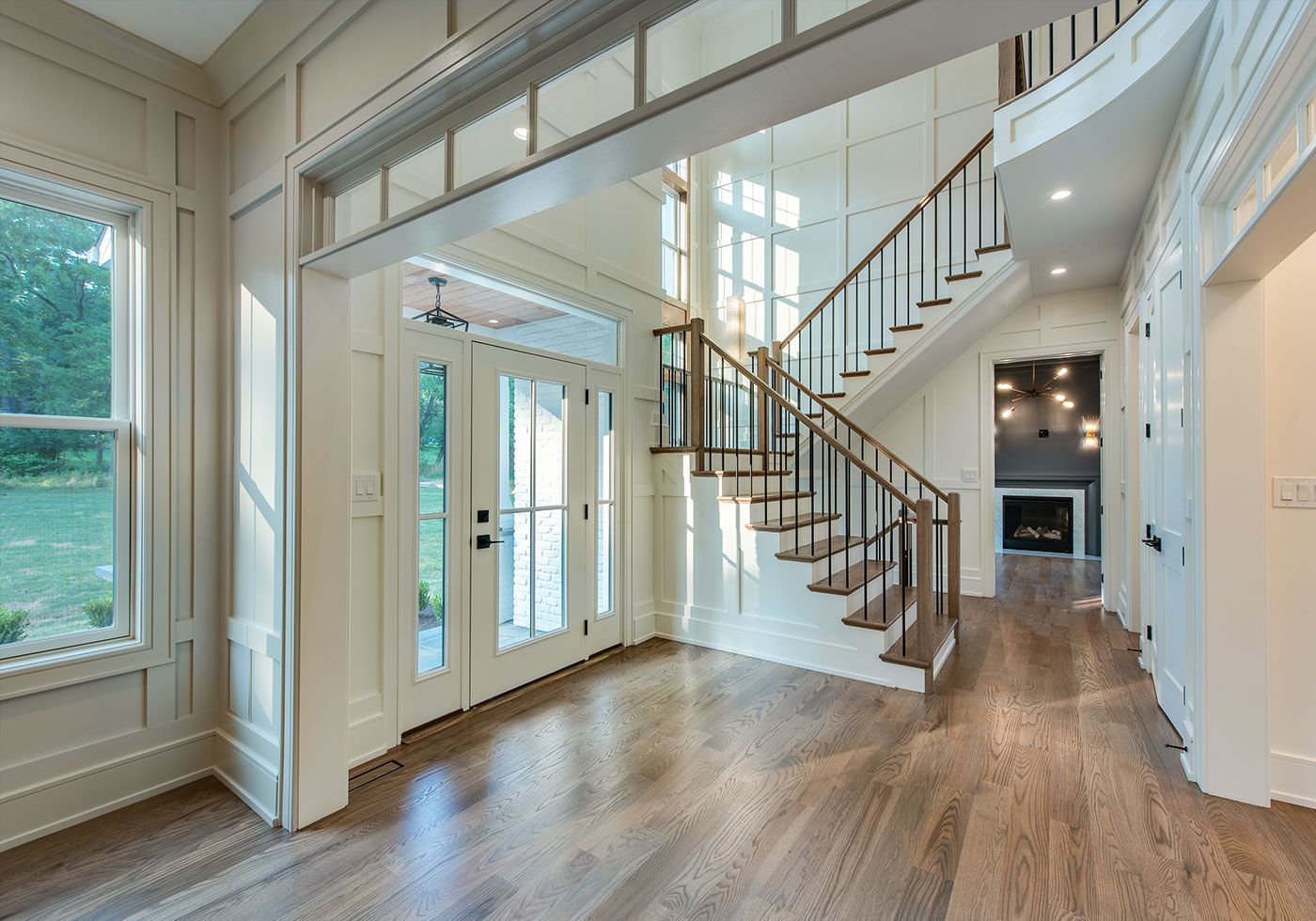 dining room and a living room separated by a unique glass divider